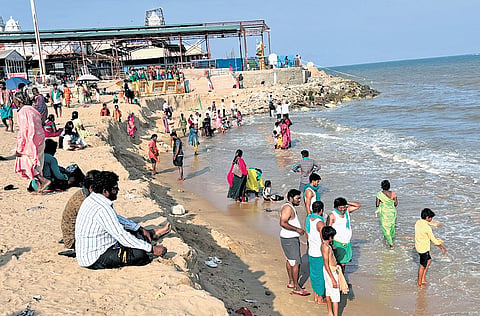 Devotees taking a bath at the Tiruchendur temple beach on Thursday
