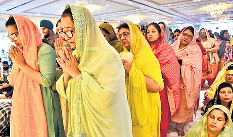 Devotees offer prayers to Guru Granth Sahib on the 558th birth anniversary of Guru Gobind Singh in Secunderabad on Sunday