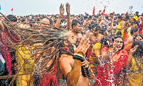 ‘Sadhus’ and other devotees take a holy dip at the Sangam on Makar Sankranti festival during the Maha Kumbh Mela in Prayagraj, Uttar Pradesh on Tuesday.