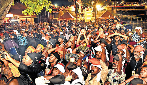 Thousands of devotees stand with folded hands in reverence as they witness Makarajyothi at Lower Thirumuttam in Sabarimala on Tuesday