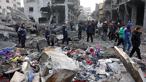 People check the rubble of buildings hit in Israeli strikes the previous night in Jabalia in the northern Gaza Strip, on January 16, 2025, following a truce announcement amid the war between Israel and the Palestinian Hamas movement.
