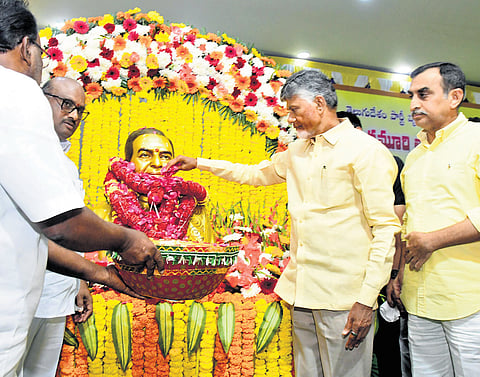 Chief Minister N Chandrababu Naidu pays floral tributes to NTR statue at Mydukur on Saturday, during the launch of Swarnandhra-Swachhandhra programme