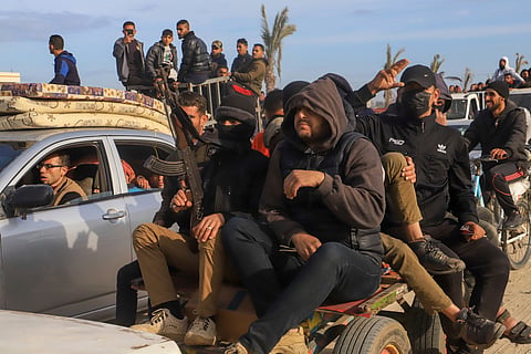 Displaced Palestinians, some armed, return to Rafah, as a ceasefire deal between Israel and Hamas went into effect, in Rafah, Gaza Strip, Sunday, Jan. 19, 2025.