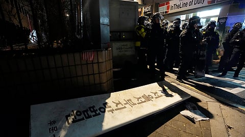 Police officers stand outside of the Seoul Western District Court after supporters of impeached South Korean President Yoon Suk Yeol broke into the court in Seoul, South Korea, Sunday, Jan. 19, 2025.