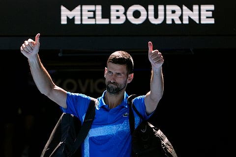 Novak Djokovic of Serbia gestures as he leaves Rod Laver Arena after retiring in his semifinal match against against Alexander Zverev of Germany