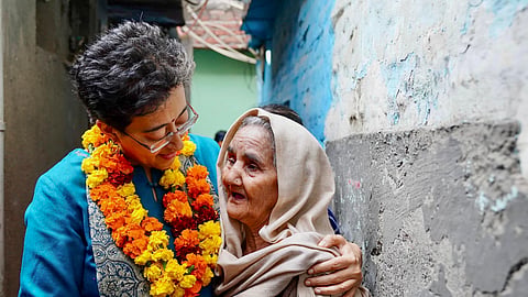 Atishi meets a supporter during her ‘padyatra’ on Thursday