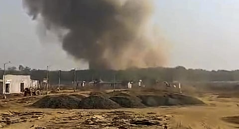 A blast is seen afar at the ordnance factory in Bhandara district, Maharashtra, Friday, Jan. 24, 2025.