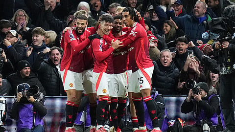 Manchester United's Lisandro Martinez, center, is congratulated after scoring his side's opening goal during the EPL soccer match between Fulham and Manchester United on Sunday, Jan. 26, 2025.