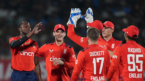 England's Jofra Archer, left, celebrates with teammate the wicket of India's Axar Patel during the Twenty20 cricket match between England and India in Rajkot, India, Tuesday, Jan. 28, 2025.