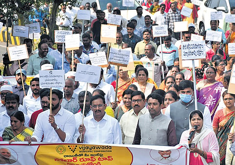 MP Kesineni Sivanath, NTR Collector G Lakshmisha and other officials take part in a rally to raise awareness on PM Surya Ghar scheme in Vijayawada