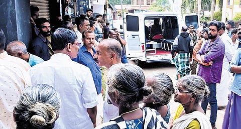 Residents gather near the house at Balaramapuram where the toddler was thrown into the well by her uncle