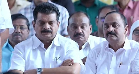 P V Anvar sitting next to opposition leader V D Satheesan during the public meeting.