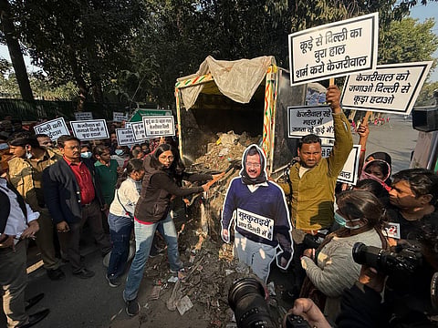 Rajya Sabha MP Swati Malliwal dumping garbage outside AAP supremo Arvind Kejriwal's residence.