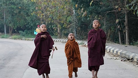 Buddhist novice monks shout to collect their morning alms Saturday, Feb. 1, 2025, in Naypyitaw, Myanmar.