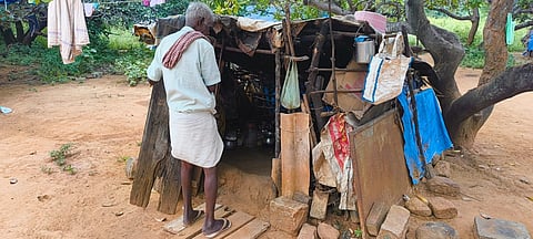 Elderly tribal man set up kitchen near his hut at in the Vasudevanallur Thalaiyanai area.