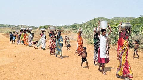 People on way to collect water in a village of Kendrapara