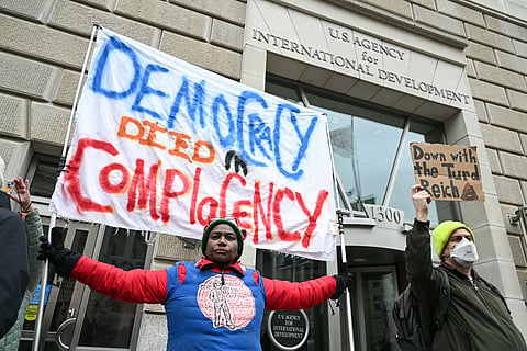People protest outside of the headquarters for United States Agency for International Development (USAID), before Congressional Democrats hold news conference in Washington, DC, on February 3, 2025.