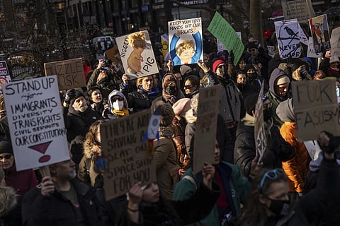 Demonstrators raise slogans during a protest outside City Hall, Wednesday, Feb 5, 2025, in New York.