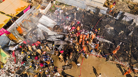 Firefighters douse a fire which broke out at a camp during the ongoing Maha Kumbh Mela 2025, in Prayagraj, Uttar Pradesh