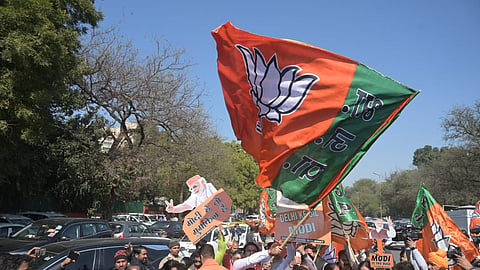 BJP workers celebrate outside the Delhi BJP office in New Delhi on Saturday.