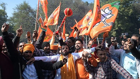 BJP workers celebrate outside the Delhi BJP office in New Delhi on Saturday.