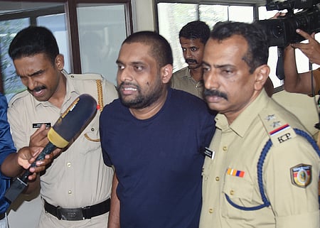 Police accompany Ananthu Krishnan, the accused in the half-price scam, to Ashoka Flats near the High Court in Kochi for evidence collection.