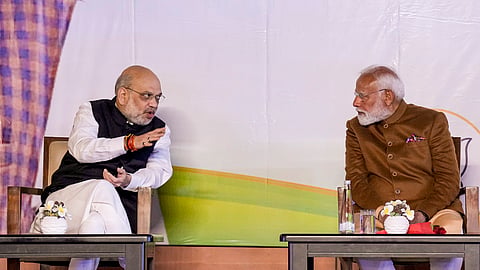 Prime Minister Narendra Modi with Union Home Minister Amit Shah during celebrations at the BJP HQ after the party won the Delhi Assembly election, in New Delhi, Saturday, Feb. 8, 2025.