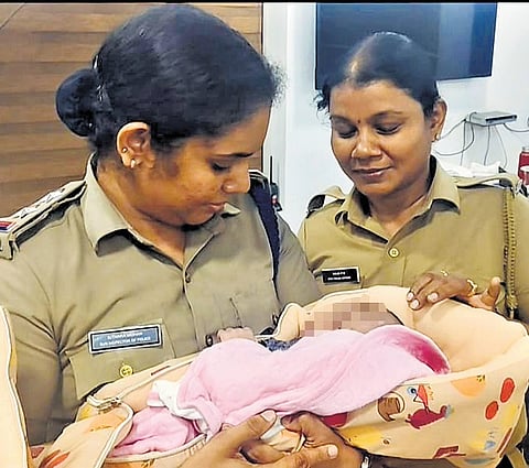 Sub-inspector Sithara Mohan and SCPO Naiju with the rescued baby