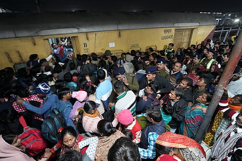 Heavy rush of passengers to catch a train for Mahakumbh, at the New Delhi railway station, Saturday, Feb. 15, 2025.