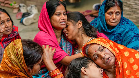 Relatives of 38-year-old Pinky Devi, who died in a stampede at the New Delhi Railway Station, mourn her death, at Sangam Vihar in New Delhi, Sunday, Feb. 16, 2025.