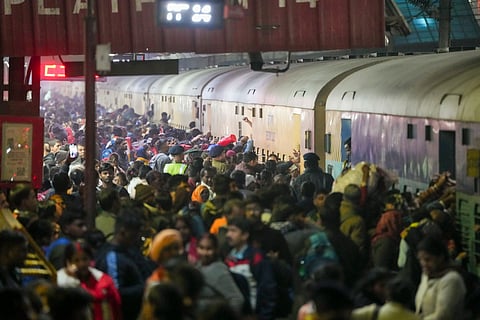 Passengers board an overcrowded train for Prayagraj's Mahakumbh, at the New Delhi railway station, Saturday, Feb. 15, 2025.
