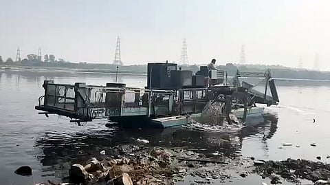 Trash Skimmer conducts a cleaning operation of Yamuna River, in New Delhi on Sunday.