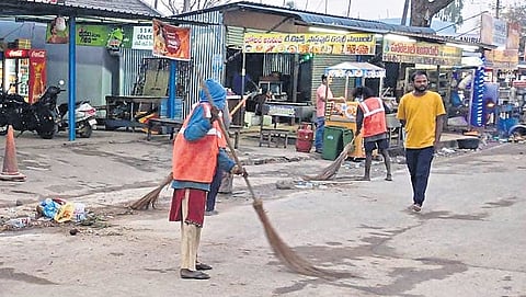 Sanitation workers sweep roads in Mulugu district. The administration has deployed over 400 sanitation workers in Medaram village