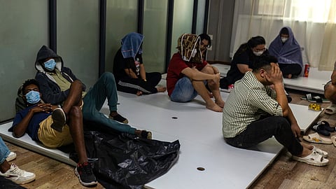 Alleged scam centre workers and victims rest during a crackdown operation by the Karen Border Guard Force (BGF) on illicit activity in Shwe Kokko in Myanmar's eastern Myawaddy township on February 18, 2025.