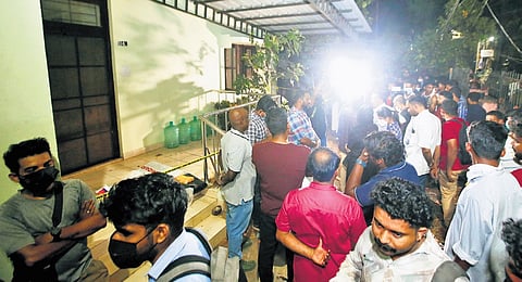 Residents gathered in front of the Kakkanad customs quarters