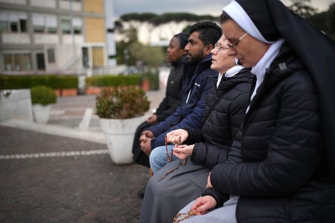 Nuns pray for Pope Francis in front of the statue of Pope John Paul II at the Agostino Gemelli Polyclinic, in Rome, Thursday, Feb. 20, 2025, where the Pontiff is hospitalized since Friday, Feb. 14.
