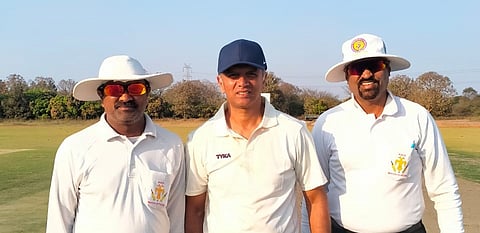 Former India head coach Rahul Dravid with match officials RV Pradhankumar Urs (R) and M Sathish