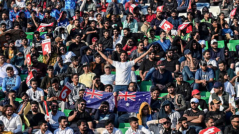 Fans cheer while watching the ICC Champions Trophy one-day international (ODI) cricket match between Australia and England at the Gaddafi Stadium in Lahore on February 22, 2025.