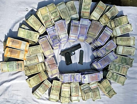 The money and illegal firearms confiscated from the extortion racket headed by USA-based gangster.