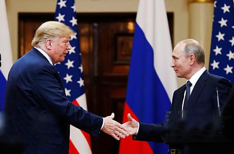 In this file photo taken on Monday, July 16, 2018, U.S. President Donald Trump shakes hand with Russian President Vladimir Putin.