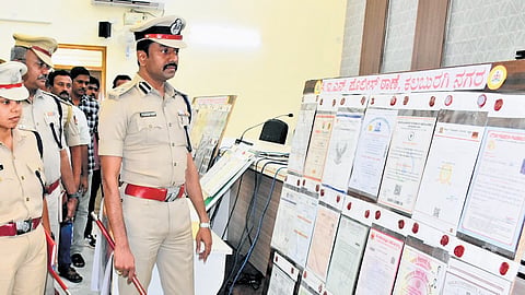 Police show the fake marks cards at a press conference on Thursday