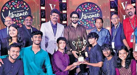 Actor Naga Chaitanya handing over the trophy to winners of Vibrance 2025