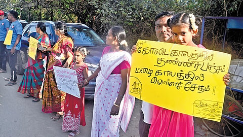 A human chain formed by residents of Thiruneermalai to draw attention of the state government to take measures to desilt Periya Eri in the area.