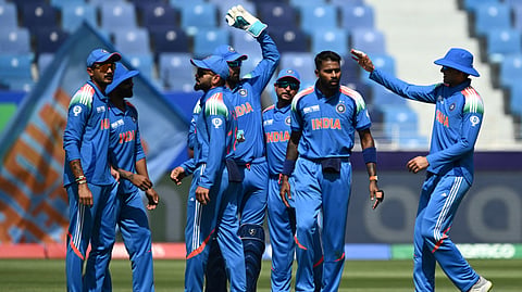 India's Hardik Pandya (2R) celebrates with teammates after taking the wicket of Pakistan's Babar Azam during the ICC Champions Trophy one-day international (ODI) cricket match between Pakistan and India at the Dubai International Stadium in Dubai on February 23, 2025.