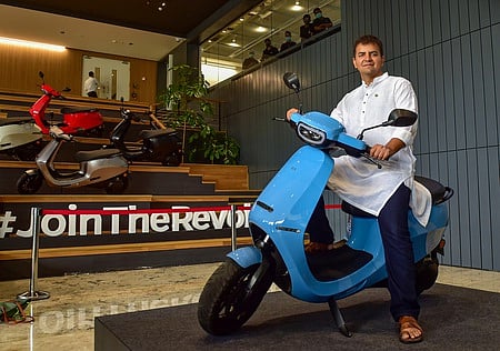 Ola founder and CEO Bhavish Aggarwal poses with newly launched OLA E-Scooter at a launch press conference in Bengaluru.
