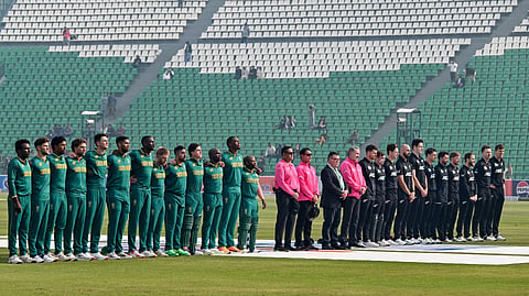 New Zealand (R) and South Africa players stand for the national anthem before the start of their second Tri-Nation series one-day international cricket match between New Zealand and South Africa at the Gaddafi Stadium in Lahore on February 10, 2025.