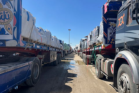Trucks line up at the Egyptian side of the Rafah border crossing between Egypt and the Gaza Strip after Israel blocked the entry of aid trucks into Gaza, Sunday, March 2, 2025.