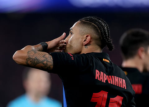 Barcelona's Raphinha celebrates scoring his team's first goal during the UEFA Champions League Round of 16 first leg football match between SL Benfica and FC Barcelona on March 5, 2025.