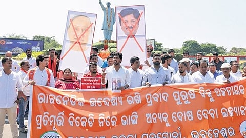 BJP Yuva Morcha activists protest near the statue of former CM Biju Patnaik at Biju Patnaik International Airport on Thursday