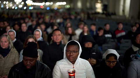 Catholic worshippers pray during a prayer of the Rosary for Pope Francis in St. Peter's Square at The Vatican, Thursday, March 6, 2025.